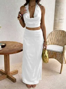 Elegant white halter neck crop top and high-waisted maxi skirt set for women's summer fashion