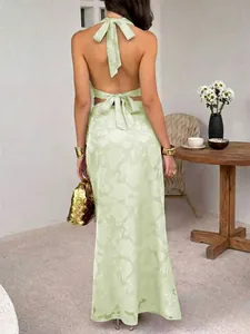 Stylish back view of a mint green halter neck backless top and maxi skirt set.