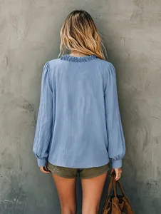 Detailed back view of a light blue casual loose long-sleeved blouse with ruffled collar
