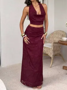 Chic burgundy Y2K halter crop top and matching textured maxi skirt set for elegant women