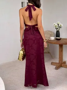 Close-up back view of a burgundy backless halter neck top and textured maxi skirt set.