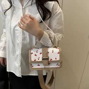 Stylish white crossbody bag featuring a cute cherry print and beige trim for women
