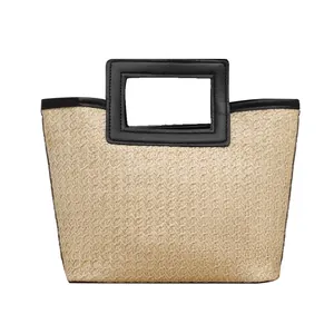 Elegant hand-woven straw tote bag featuring a unique square black cutout handle design