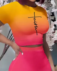 Close-up detail of vibrant ombre crop top and skirt set with faith script print