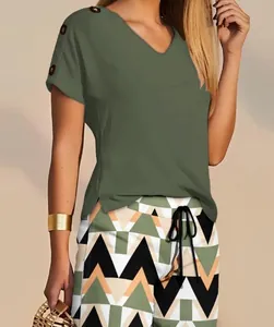 Detail of V-neck casual top with shoulder button accents and geometric print shorts