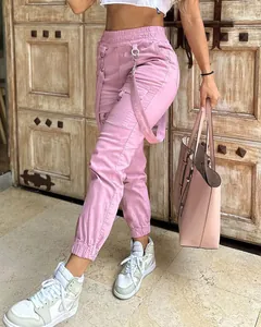 Detail view of pink retro cargo joggers with elastic waist and multi-pocket design.