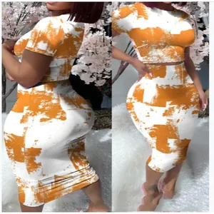 Close-up of women's orange and white abstract print crop top and midi skirt set