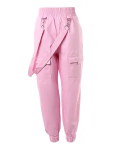 Detailed view of pink cargo pants featuring an elastic waist and multiple utility pockets.