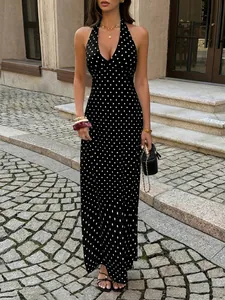 Elegant full-length view of a sexy black and white polka dot halter neck maxi dress on model