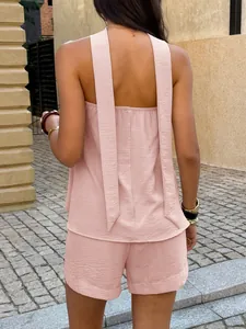 Back view of a pink minimalist two-piece set featuring a sleeveless top and shorts.