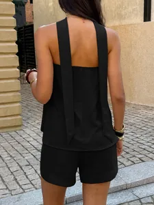 Back view of minimalist black two-piece set with elegant sleeveless top and shorts