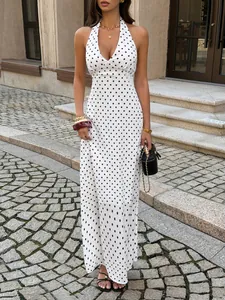 Elegant white polka dot halter maxi dress with deep V-neck for summer fashion trends
