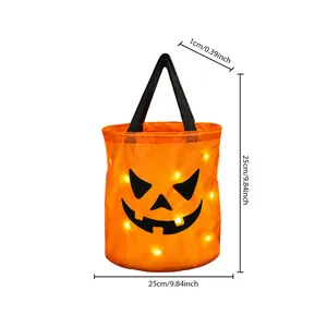 Close-up detail of LED light-up Halloween pumpkin candy bucket showing 25cm dimensions