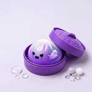 Close-up detail of Halloween ghost bun squishy toy set inside a purple steamer basket