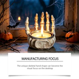 Detailed view of realistic skeleton hand candle holder for Halloween desk decor