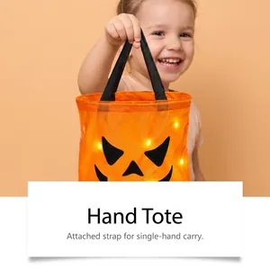 Close-up view of the LED Halloween pumpkin candy bucket with its durable carrying strap