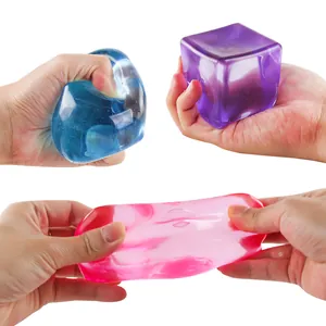 Macro view of colorful maltose ice cube squishy toys being stretched and squeezed
