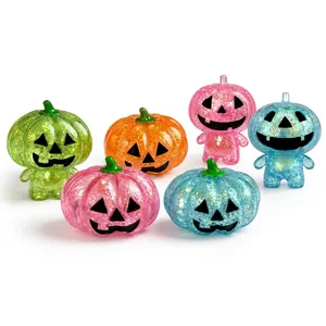 Set of colorful glittery Halloween pumpkin squishy stress relief toys on white background