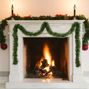 2m green Christmas tinsel garland draped over a cozy white marble fireplace mantle display