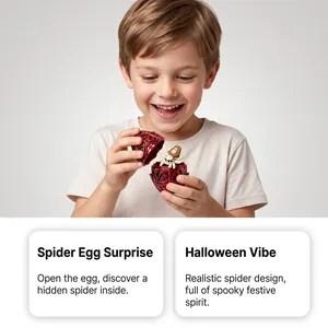 Detailed view of a red filigree spider egg toy opened to reveal a cute hidden spider inside.