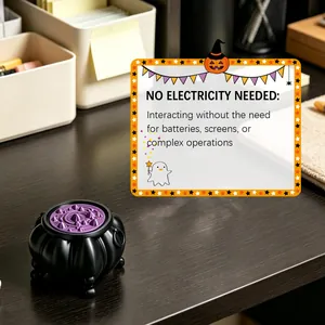 Detail of Halloween witch cauldron toy showing manual interaction and no power needs.