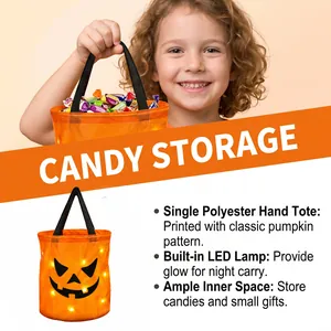 Close-up of LED pumpkin candy bucket showing glowing jack-o'-lantern face