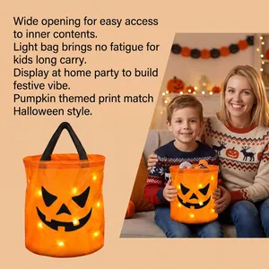 Detail of glowing LED pumpkin candy bucket used in a festive home setting.