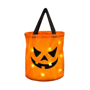 Glowing orange Halloween LED pumpkin candy bucket with black handle for trick-or-treating
