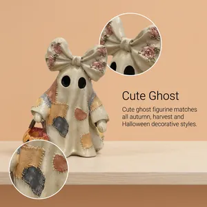 Detailed close-up view of a vintage patchwork ghost figurine with a pink rose bow