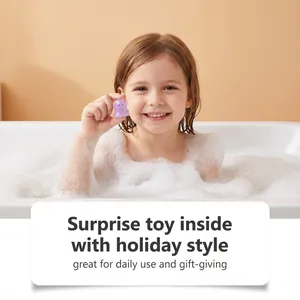 Child in a bubble bath holding a small purple ghost toy from Halloween bath bomb