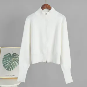 Full view of white knitted sweater featuring a stand-up collar and double zippers
