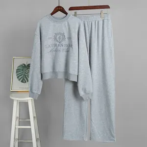 Premium two-piece grey embroidered sweatshirt and wide-leg sweatpants lounging set.
