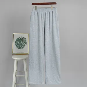 Detailed studio shot of women's light grey casual sweatpants hanging on a minimalist hanger