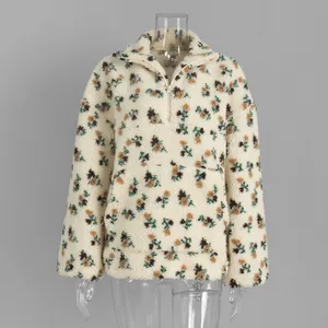 Detail view of floral print sherpa fleece sweatshirt featuring a half-zip and front pocket