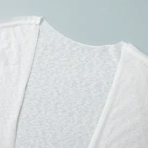 Close-up of lightweight semi-transparent fabric and collar detail on white beach robe