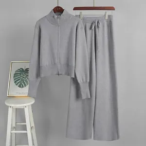 Two-piece grey knitted set with double-zipper cardigan and matching wide-leg trousers