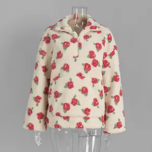 Warm cream-colored fleece sweatshirt featuring a vibrant red floral print and half-zip closure