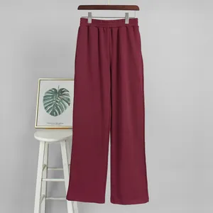Detail view of wine red casual sweatpants with elastic waist and straight leg fit