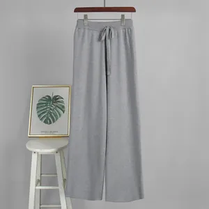 Gray knit wide-leg pants with drawstring waist hanging against a neutral background