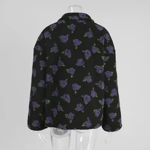 Back view detail of black fleece sweatshirt with purple floral patterns on a mannequin.