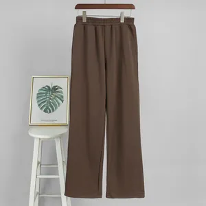 Front view of brown wide-leg casual sweatpants hanging on a wooden hanger for women