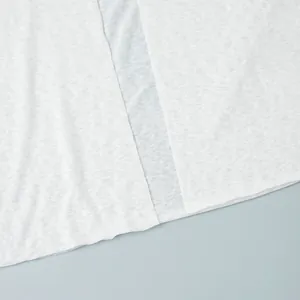 Close-up detail showing the texture of white semi-transparent knit beachwear fabric