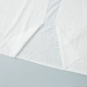 Detailed view of the lightweight white semi-transparent fabric for beachwear set
