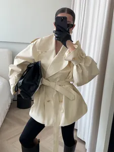 Fashionable cream faux leather mid-length trench coat with double-breasted lapel and belt