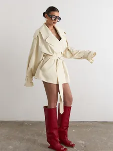 Stylish beige mid-length trench coat with oversized lapel and belt for women.
