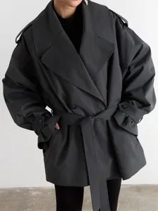 Front view of charcoal gray oversized double-breasted trench coat with waist belt