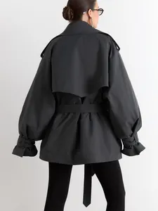 Back view of a charcoal grey mid-length trench coat with waist belt and lantern sleeves