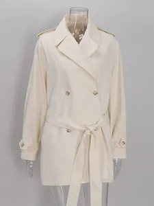 Frontal detail view of a cream double-breasted trench coat with belt on a mannequin