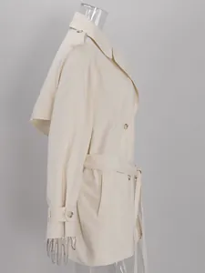 Side view detail of a chic cream double-breasted belted trench coat on mannequin
