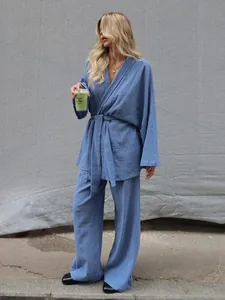 Detail of blue cotton pajama set with waffle texture and wrap-style belted top